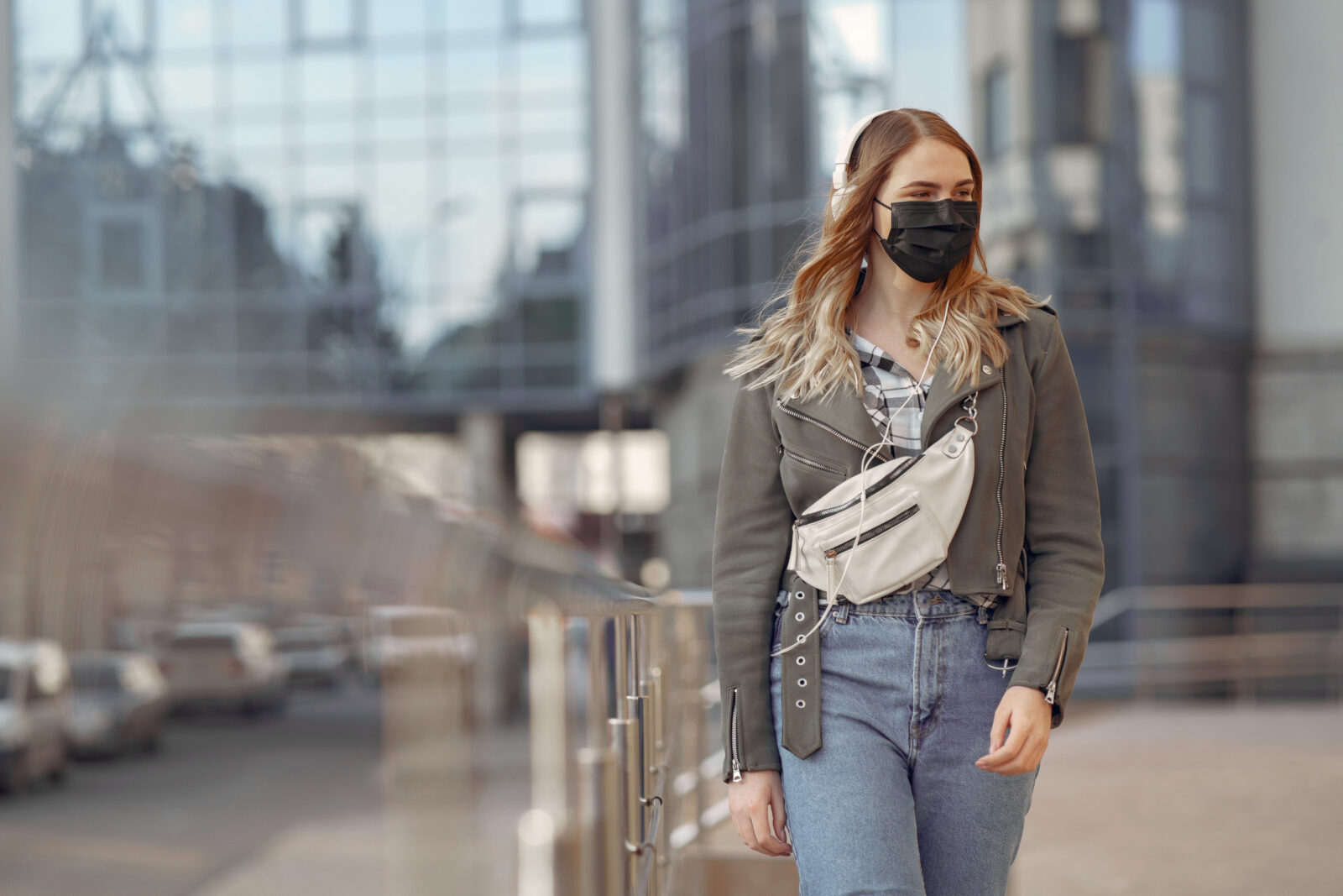 Woman in a mask stands on the street
